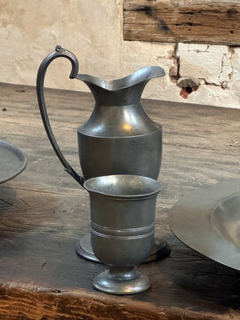 Antique Pewter Pitcher and Goblet on Rustic Wooden Table
