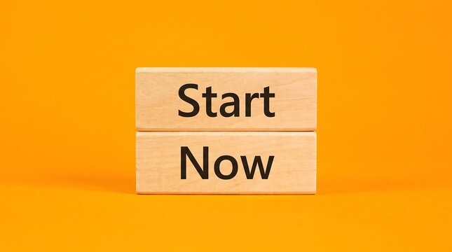 Start Now motivational text on wooden blocks, business beginning concept on orange background, career launch and initiative message