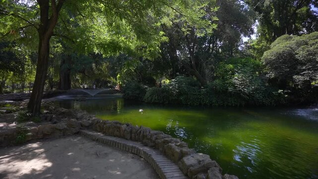 View of fountain and pond in Parque de Mari&shy;a Luisa on a sunny day, Seville, Andalusia, Spain