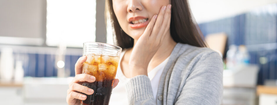 Health care asian young woman touching mouth, expression, girl suffering from toothache, decay or sensitivity cavity molar tooth or inflammation drink cold, sparkling water. Sensitive teeth people.