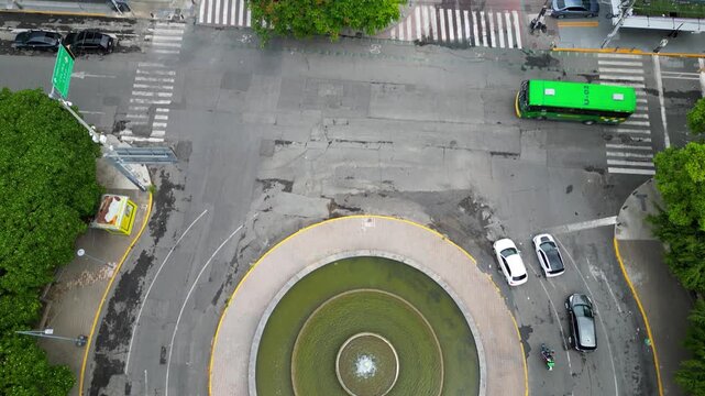Drone video showing Chapultepec fountain and avenue surrounded by traffic and trees