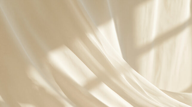 Elegant beige fabric folds with soft window shadows at sunrise