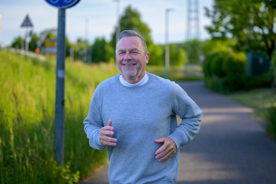 Happy Senior Man Running Outdoors