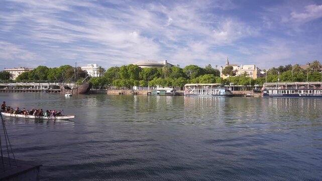 View of Canal de Alfonso XIII river and Torre del Oro (the Golden Tower) on a sunny day, Seville, Andalusia, Spain