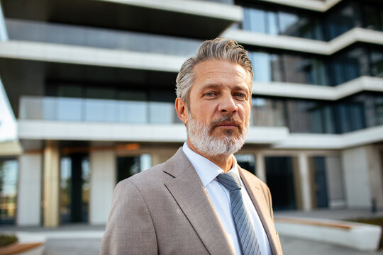 Portrait of a confident senior businessman outside a modern office building