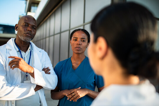 Doctors and nurses discussing outside hospital