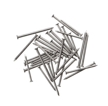 Pile of metal nails scattered on a white background