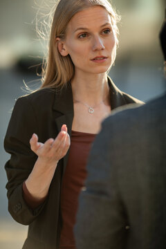 Businesswoman gesturing during serious conversation outdoors