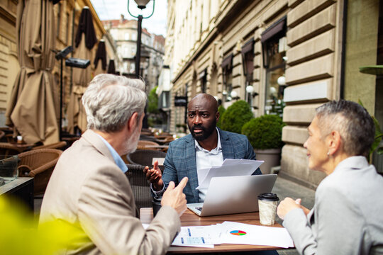 Business colleagues meeting at outdoor city cafe