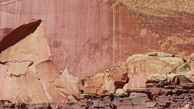 Ancient Fremont Culture petroglyphs showing anthropomorphic figures and animals etched into sandstone walls at Capitol Reef National Park Utah