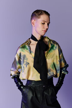 A stylish young queer non binary person poses in a chic setting, showing bold fashion.