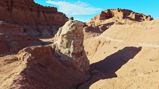 Morning sunlight illuminates unique sandstone  weathered rock formations along the Basilisk Trail in Goblin Valley State Park Utah
