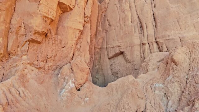 Sunlight filters into the massive eroded sandstone cavern chamber of Goblin&rsquo;s Lair at Goblin Valley State Park in Utah