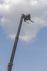Extremely Tall Forklift Boom Lift Reach Over Blue Sky © markobe