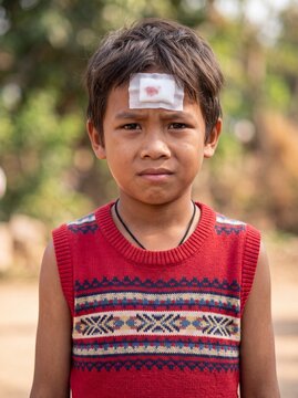Portrait of Young Boy With Forehead Bandage Outdoors