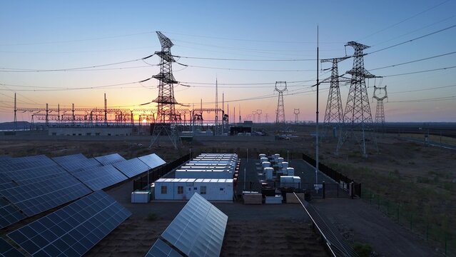 photovoltaic energy storage power station and transmission tower sunset landscape