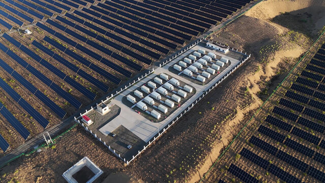 Aerial view of solar panel arrays and energy storage power station facilities