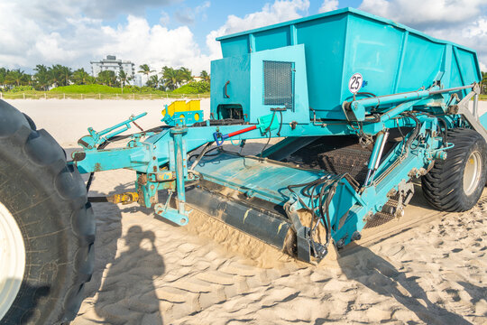 Tractor cleaning sand in South beach in Miami