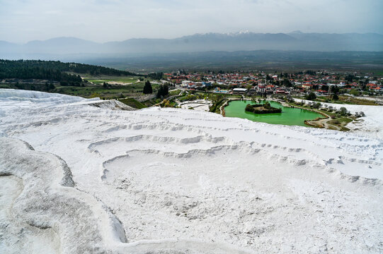 White travertine terraces of Pamukkale overlooking the lake near the town of Pamukkale a world-famous natural wonder and thermal springs Denizli Province, T&uuml;rkiye 
