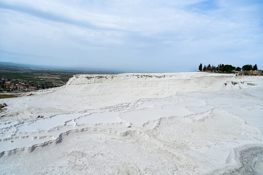 White travertine terraces of Pamukkale overlooking the lake near the town of Pamukkale a world-famous natural wonder and thermal springs Denizli Province, T&uuml;rkiye 