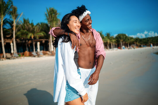 Romantic young couple enjoying their tropical honeymoon on a beautiful sunny beach