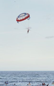 Parasailing over the sea. Da Nang coast. Active leisure. Parachute against a blue sky.