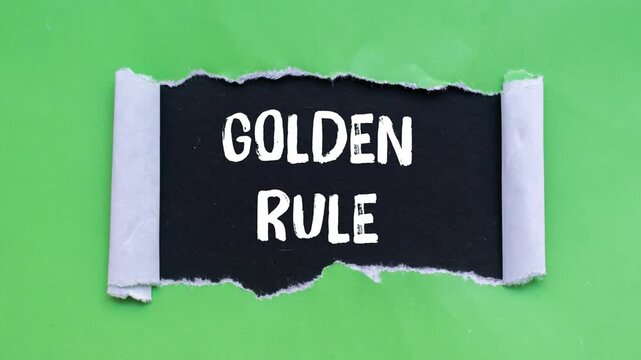 Golden rule message writing on ripped torn paper background
