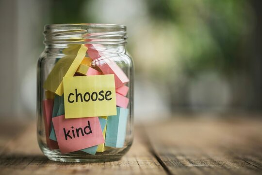 Glass jar filled with colorful sticky notes featuring choose kind text