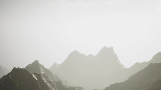 The scene shows tall mountains shrouded in mist with a bright sky above. The setting appears quiet and expansive. This is likely a natural area that is remote and untouched.