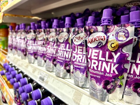 Sabah, Malaysia - September 02, 2026 : Ribena blackcurrant jelly drink pouches neatly displayed in rows on supermarket store shelf.