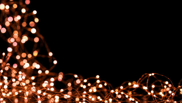 Warm glowing fairy lights tangled in the lower left corner against a dark generated using ai