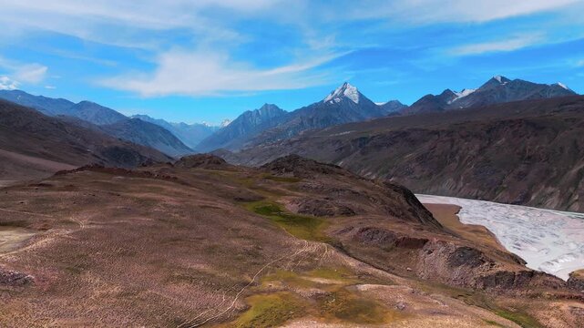 Aerial Drone View of the Chandra River Winding Through Rugged Himalayan Mountains in Spiti Valley, Himachal Pradesh with Rocky Slopes, Deep Valleys and Dramatic High Altitude Scenery