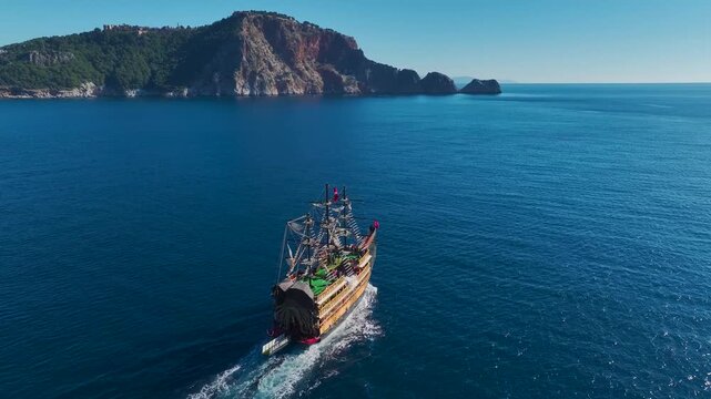 Aerial Video Pirate Ship Heading To The Old Port On A Sunny Day, Surrounded By The Deep Blue Ocean And Bright Sky