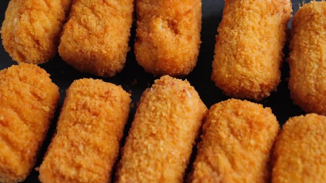 Close-up of Spanish chicken croquettes, a delicate tapas appetizer with a crispy golden coating and creamy filling. High quality 4k footage