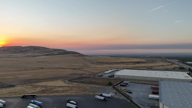 Aerial view of Interstate 5 running past large industrial warehouses