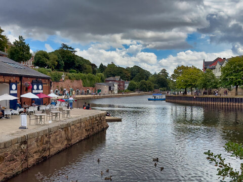 Exeter Quay and River Exe Waterfront with Historic Cellars, Outdoor Cafes, and Small Boat, Devon, UK