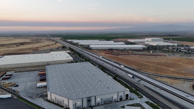 Aerial view of Interstate 5 running past large industrial warehouses