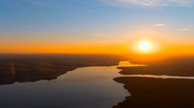 Russia, Votkinsk. The setting sun over the forest and Votkinsky pond. The Votka River and the Sharkan River. Votkinsk city in the Udmurt Republic. Drone footage