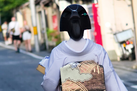 Geisha walking on a touristic street in Kyoto, Japan