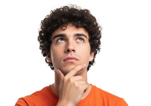 Thoughtful young man looking up with chin resting on hand