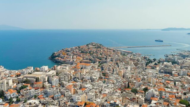 Kavala, Greece. Kavala Fortress and Aqueduct. The ferry leaves the port. Historic city center. Summer. Drone footage