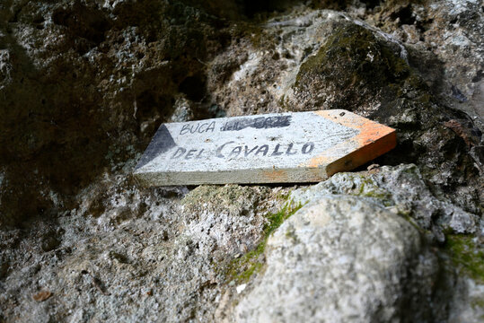 Directory markers in italian wood. Wooden signposts at parco archeologico Piano di Mommio, Massarosa, Tuscany, Italy.