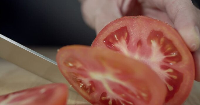Macro wide close up of knife slicing and chopping a red tomato salad, food,
