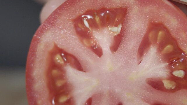 Macro wide close up of knife slicing and chopping a red tomato salad, food,