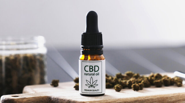 CBD Dry Cannabis For Smoking And A Bottle Of CBD Natural Oil On A Table For Calming The Nervous System