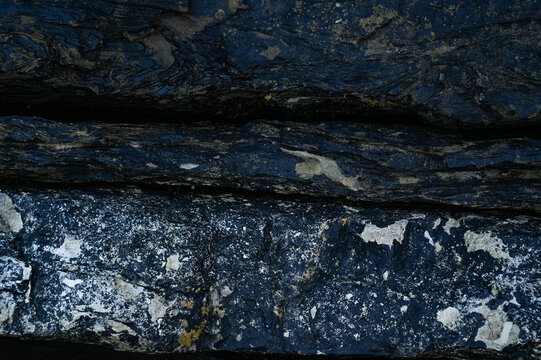 Black weathered natural stone rock background.