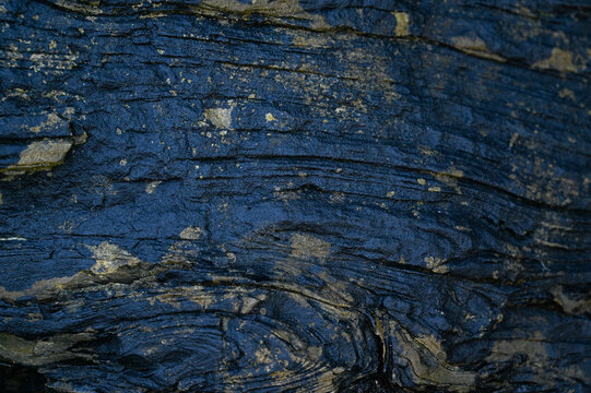 Black weathered natural stone rock background.