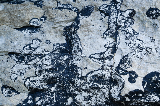 Black and white weathered natural granite stone rock background.