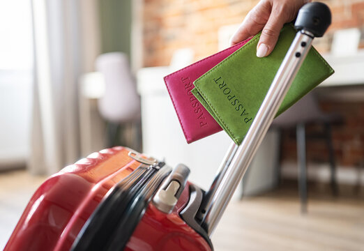 Girl Rolling Suitcase Holding Passports International Holiday Travel Concept