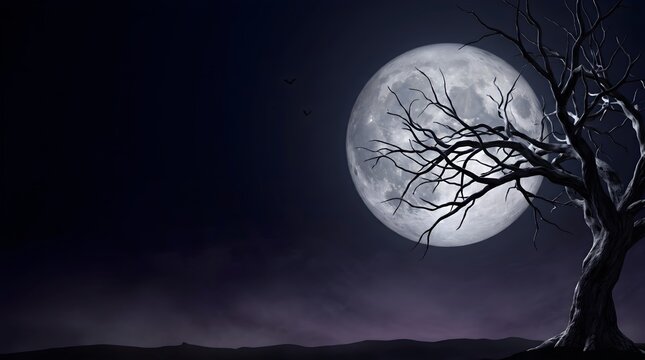 Bare tree silhouetted against a large full moon in a dark atmospheric landscape baretree silhouette moonlight nightscape darkness eerie spooky autumnal winter
